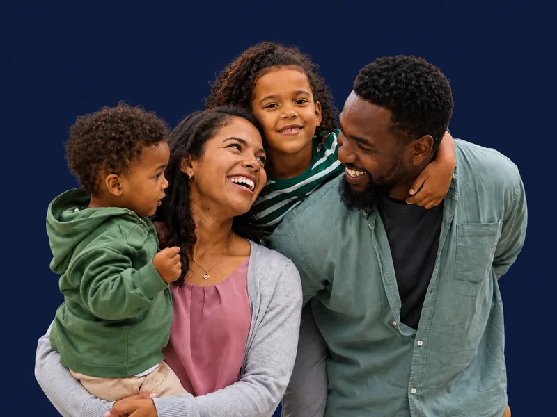 Smiling family representing homeowners protected by mortgage protection insurance